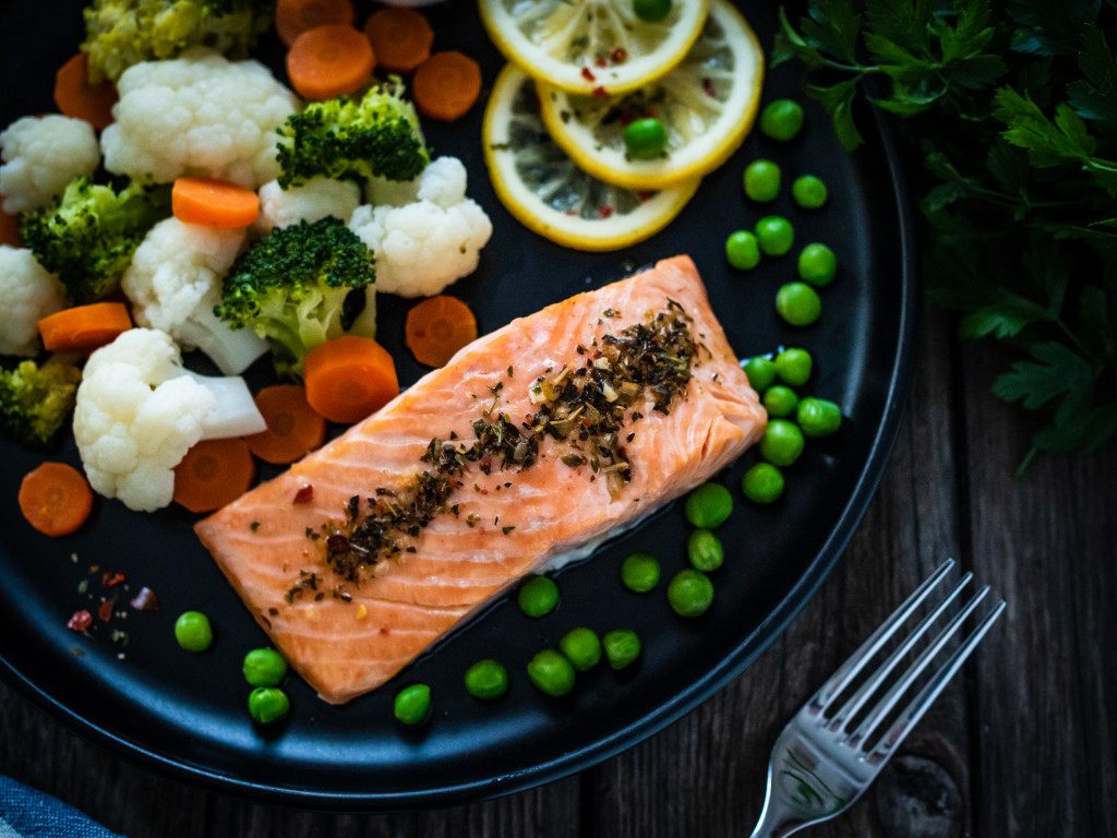 healthy steamed salmon with veggies on the side